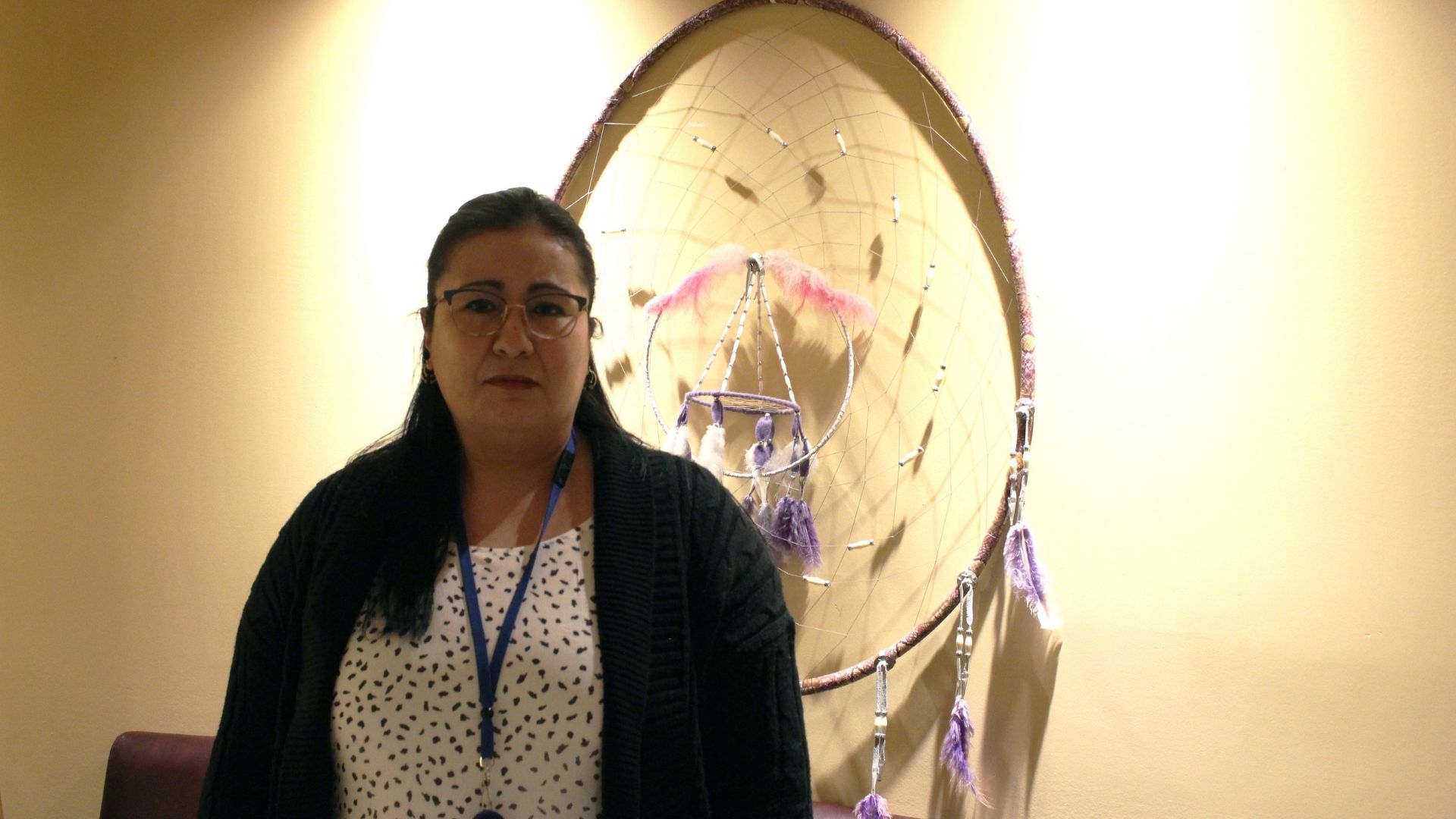 Photo of Miranda in front of a dreamcatcher